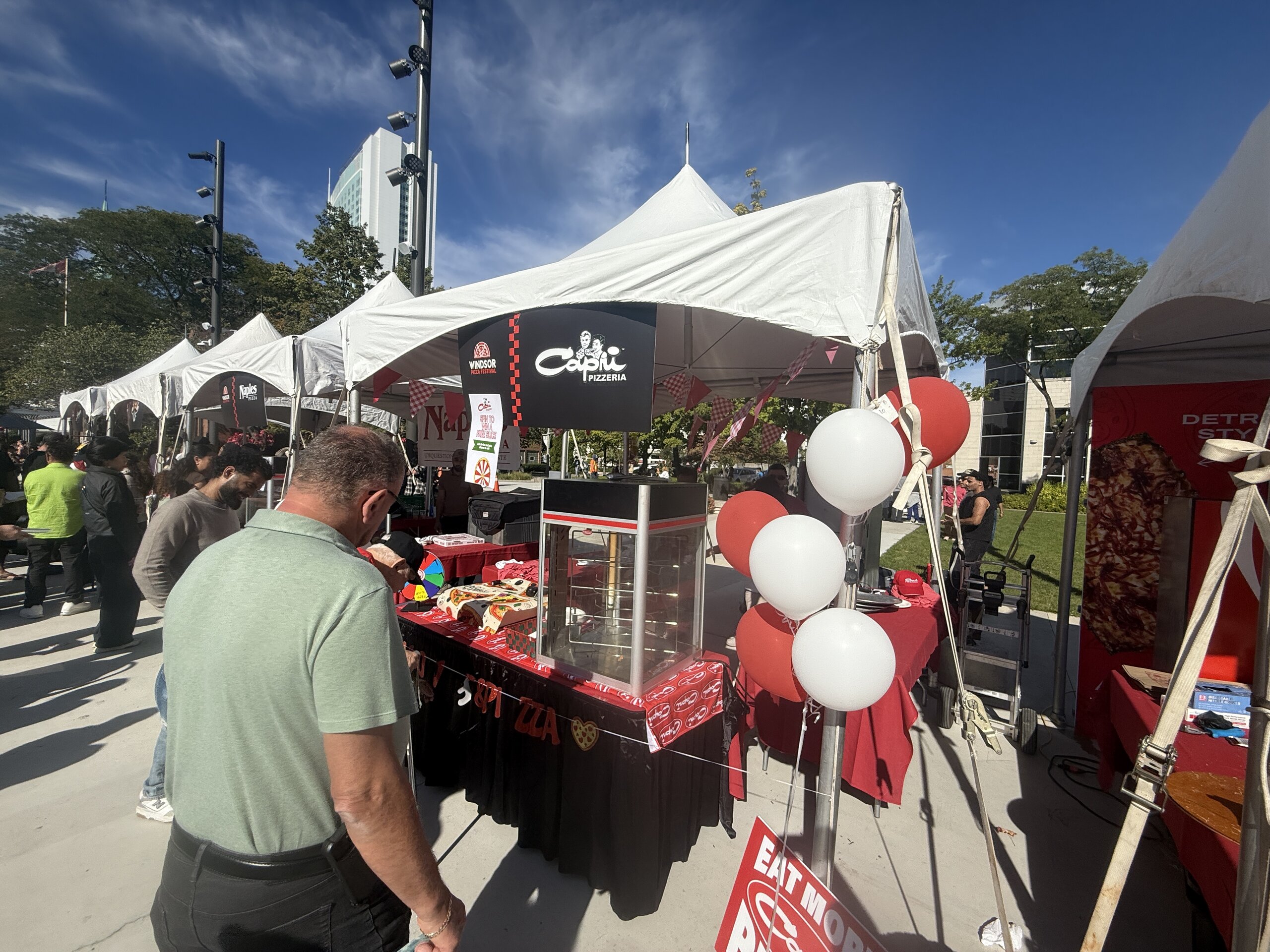 Capri Pizzeria tent with red and white balloons at the Windsor Pizza Festival 2026